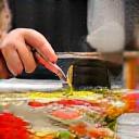 Hands preparing food with Furu Fudo meal kit ingredients